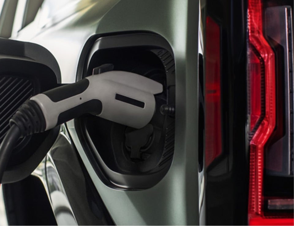 Close up of charging port with charger plugged in on a GMC Hummer EV SUV - Goldstein Buick GMC in ALBANY NY