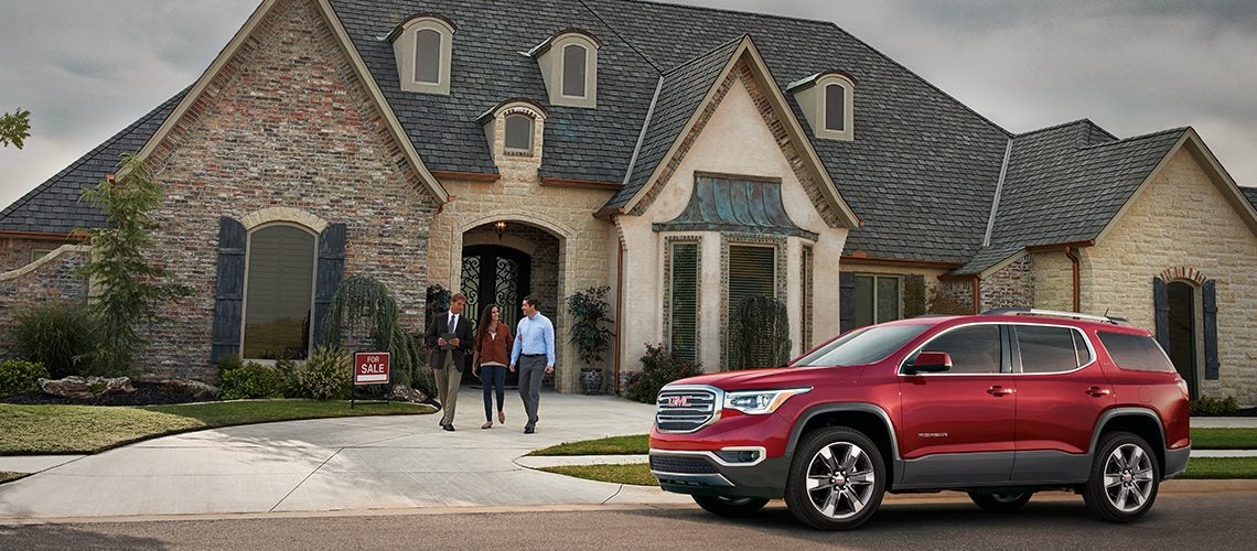 The 2018 GMC Acadia in red in front of house - Goldstein Buick GMC in Albany, NY and Colonie, NY